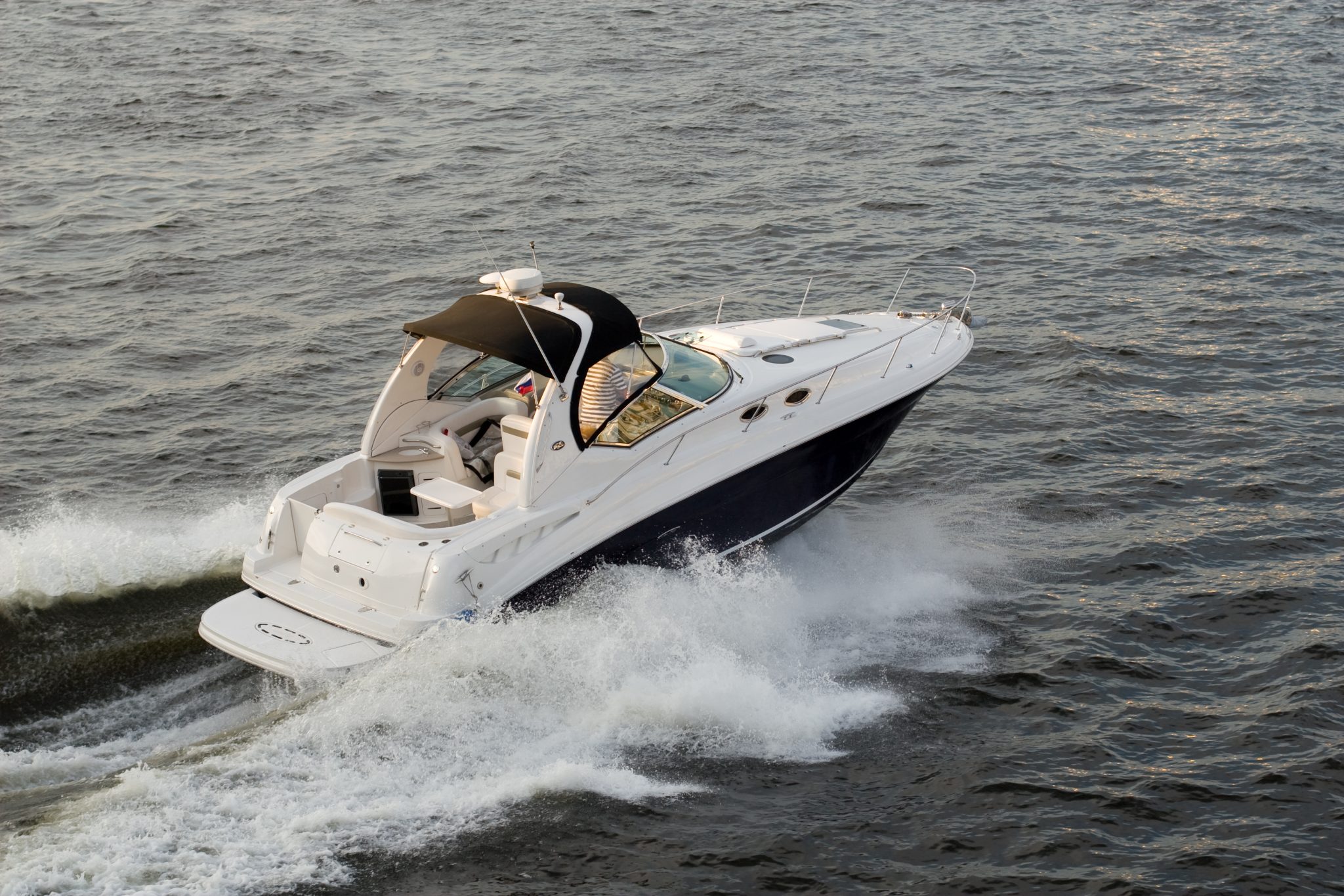 A speed boat glides through lake waters